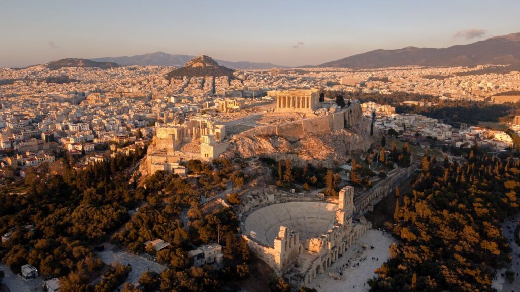 Aerial view of the acropolis in Athens, Greece, during sunset, featuring the Parthenon and the Odeon of Herodes Atticus with facts about the Acropolis of Athens and the