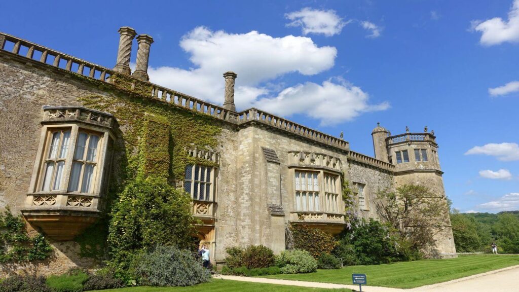 A large stone building with a green lawn perfect for family holidays.