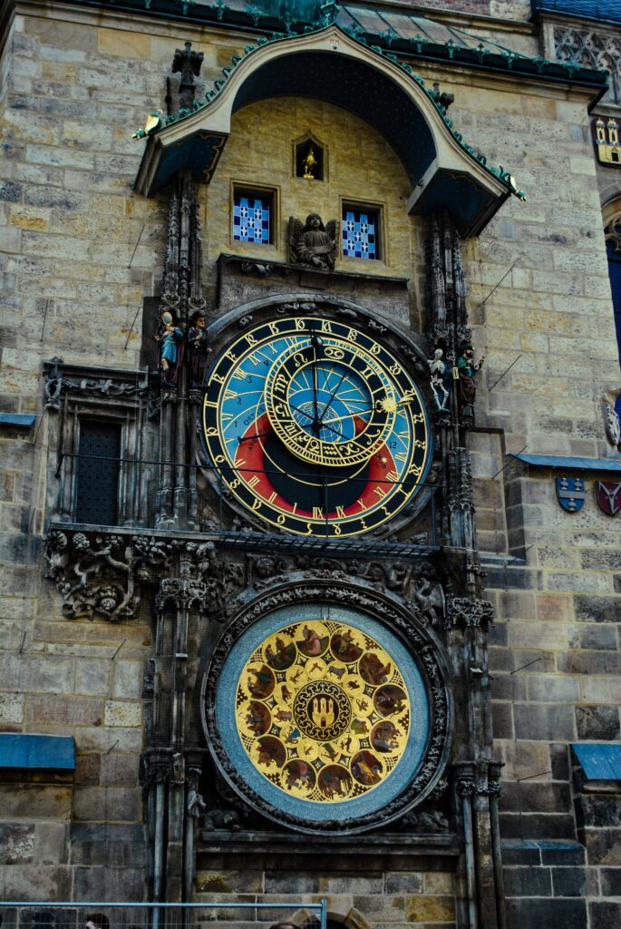 Detailed view of the astronomical clock on the old town hall in Prague, Central & Eastern Europe, featuring its colorful dials and intricate architectural details.