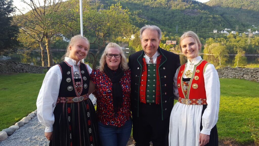 Image of Leith with Scandinavian locals, wearing traditional, brightly coloured dresses 
