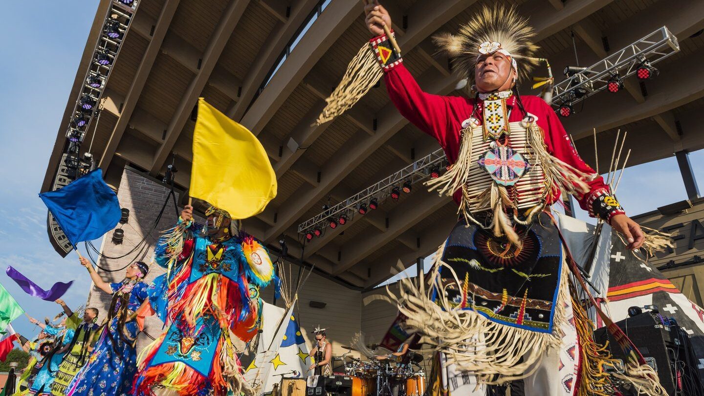Native American performance, with dancers in traditional regalia 