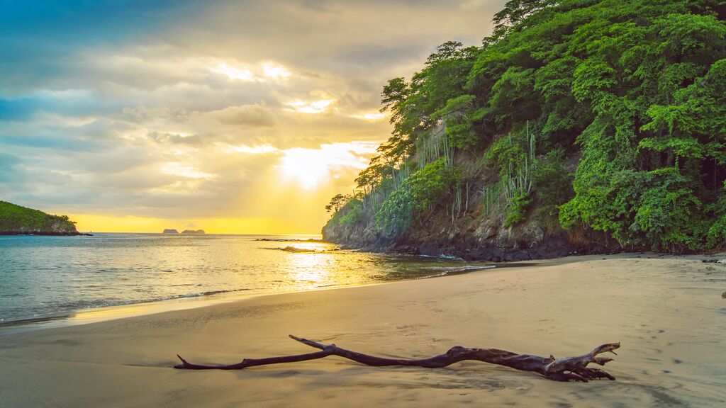 Beach in Costa Rica with the sun shining through the clouds