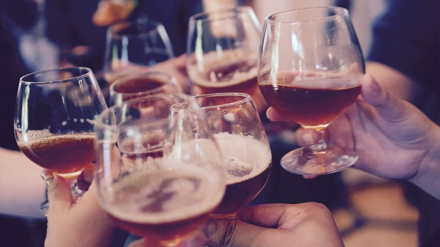 hands clinking beer glasses