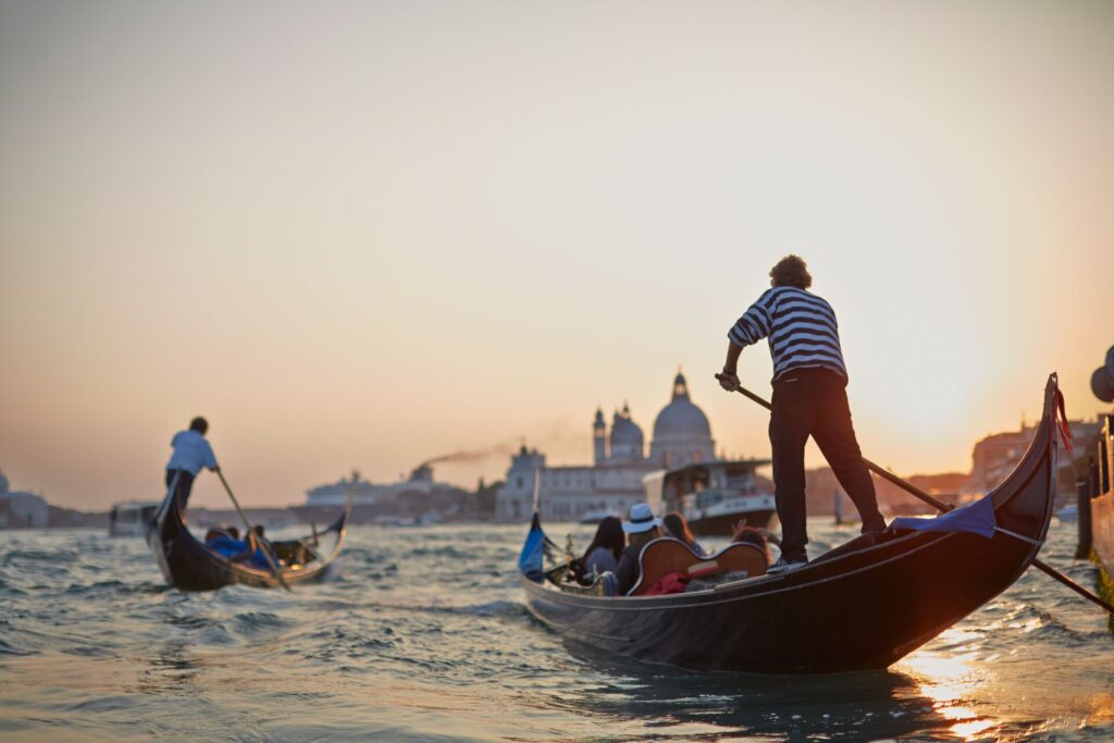 People travelling by gondola in Venice, ITaly