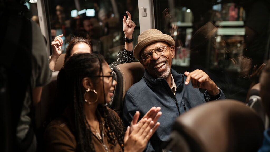 Two Trafalgar guests laughing together on board the coach