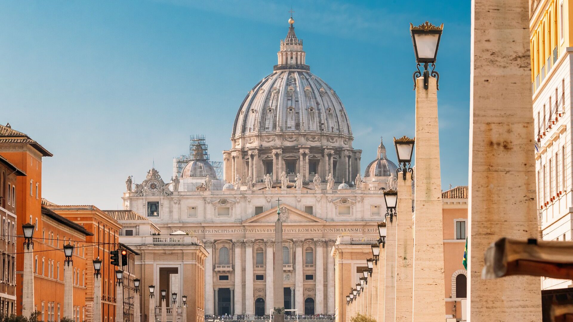 St. Peter's Basilica in Rome, close-up on the top half with buildings either side of the image.