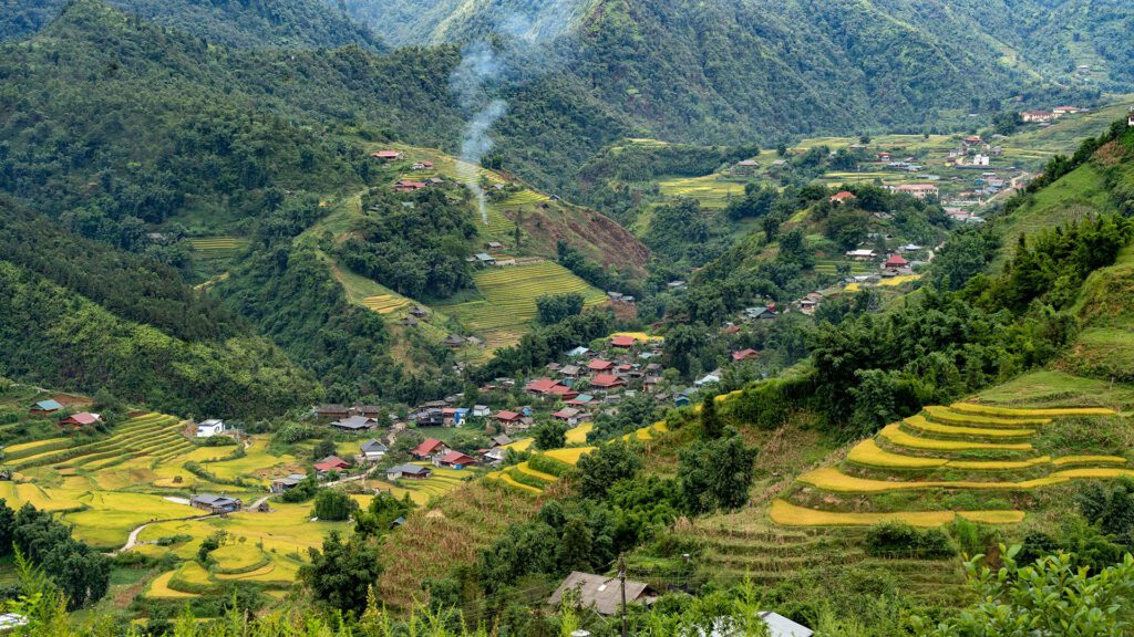 Valley with terraced rice paddies and traditional farming village 