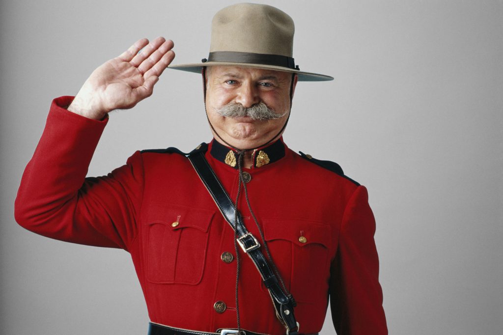 A man in a red uniform with a mustache is waving.