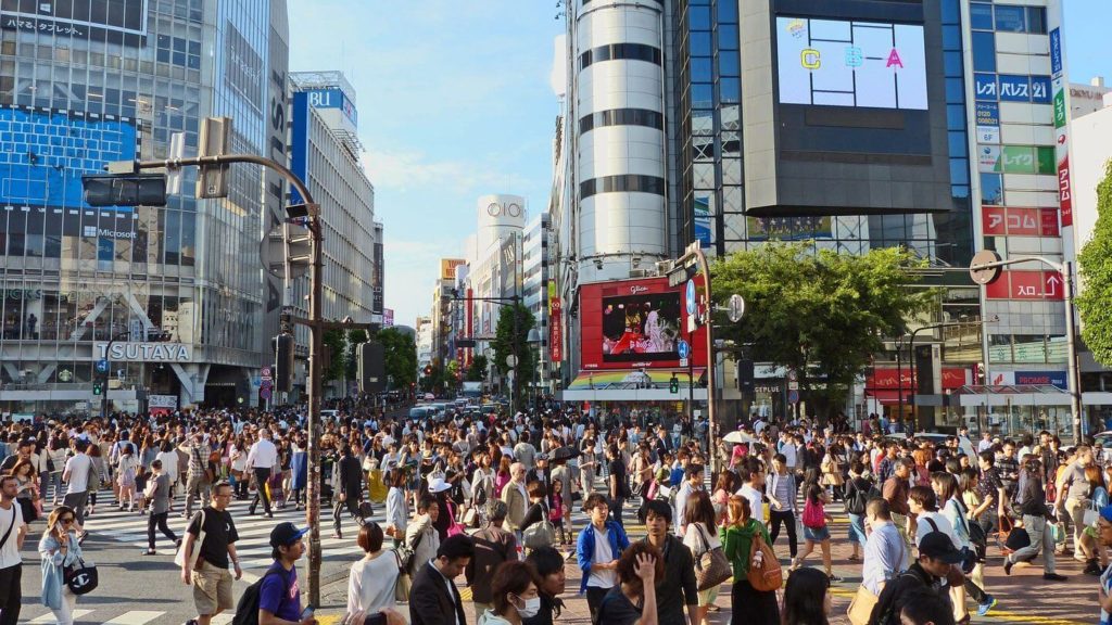 Crowd of Japanese people walking through the city