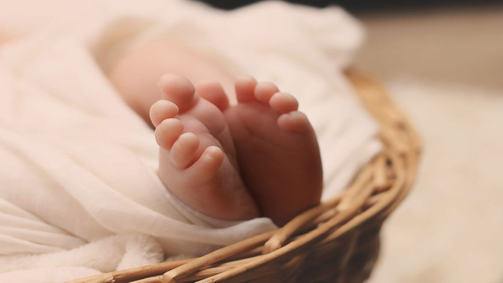 newborn feet wrapped in a blanket
