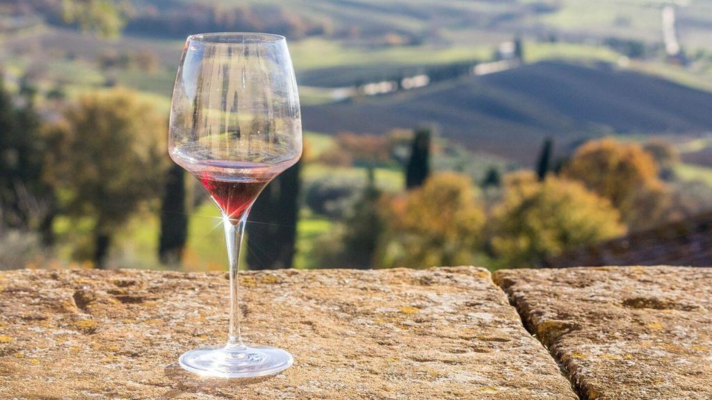 glass red wine tuscan vineyards
